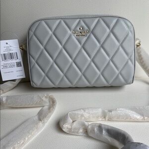 Brand new Kate Spade bag with tags. Beautiful light gray with gold hardware.